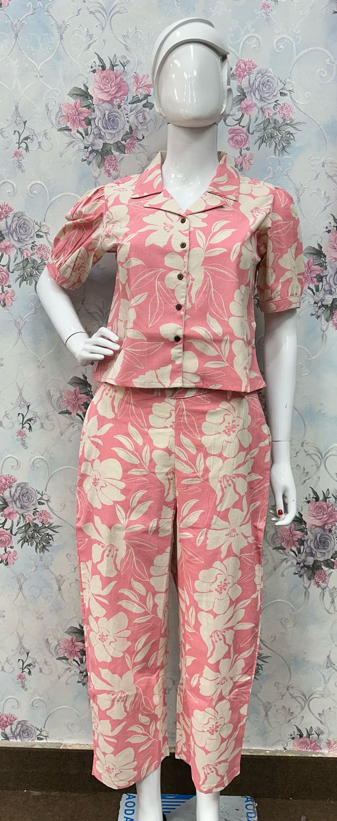 Woman wearing a pink kurti with floral patterns